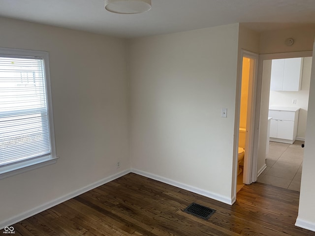 1444 N Denny St, Indianapolis, IN 46201 - unfurnished room with dark wood-type flooring and baseboards