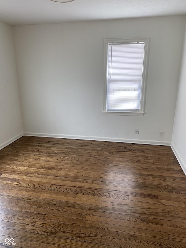 1444 N Denny St, Indianapolis, IN 46201 - unfurnished room with dark wood-type flooring and baseboards