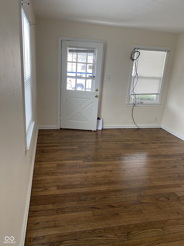 1444 N Denny St, Indianapolis, IN 46201 - doorway to outside featuring dark wood finished floors and baseboards