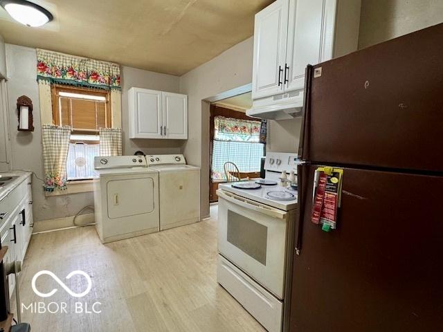1118 S 2nd St, Lafayette, IN 47905 - kitchen featuring freestanding refrigerator, electric range, separate washer and dryer, light wood-style flooring, and white cabinetry