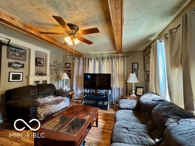1118 S 2nd St, Lafayette, IN 47905 - living area with a textured ceiling, a ceiling fan, beamed ceiling, and wood finished floors