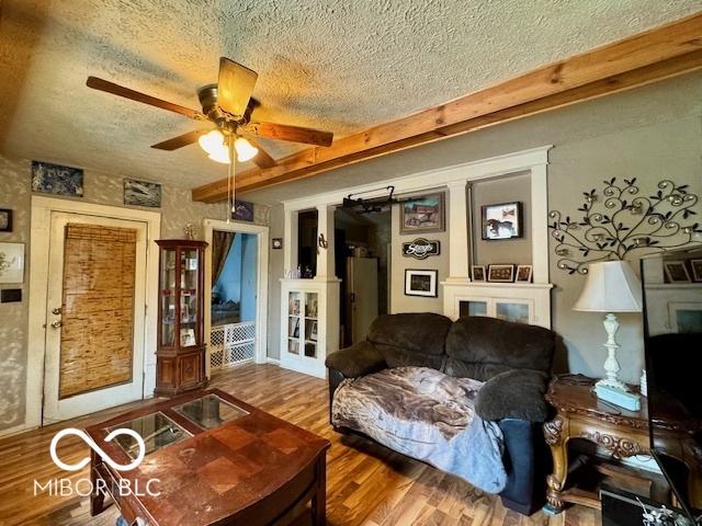 1118 S 2nd St, Lafayette, IN 47905 - living room featuring a textured ceiling, a ceiling fan, wood finished floors, and beamed ceiling