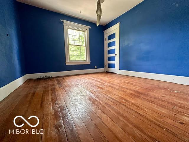 323 W 8th St, Rushville, IN 46173 - spare room featuring hardwood / wood-style flooring and baseboards