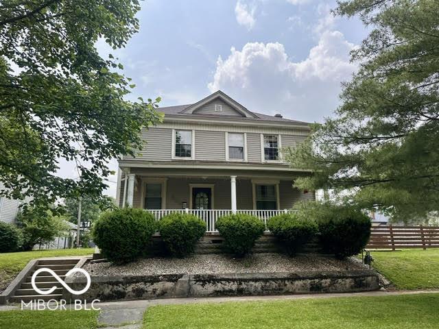 323 W 8th St, Rushville, IN 46173 - view of front of house with a porch
