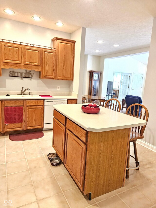 6956 Park Square Dr Unit D, Avon, IN 46123 - kitchen featuring dishwasher, a breakfast bar, a sink, light tile patterned floors, and recessed lighting