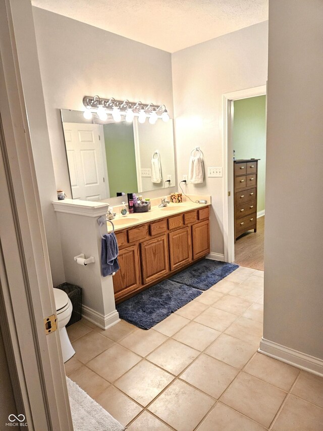 6956 Park Square Dr Unit D, Avon, IN 46123 - bathroom featuring double vanity, tile patterned flooring, toilet, and baseboards