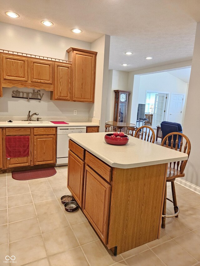 6956 Park Square Dr Unit D, Avon, IN 46123 - kitchen featuring dishwasher, a breakfast bar, a sink, light tile patterned flooring, and recessed lighting