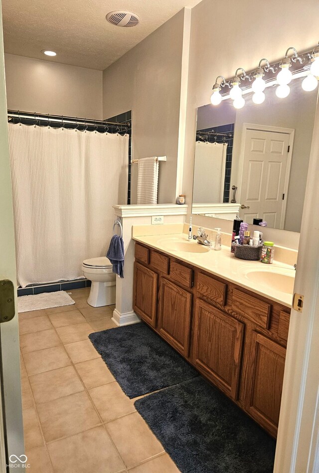 6956 Park Square Dr Unit D, Avon, IN 46123 - bathroom featuring tile patterned flooring, double vanity, toilet, and a shower with curtain