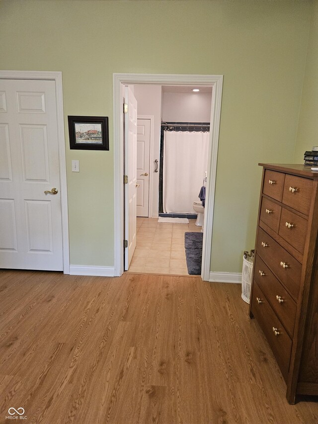 6956 Park Square Dr Unit D, Avon, IN 46123 - bedroom with baseboards, wood finished floors, and connected bathroom