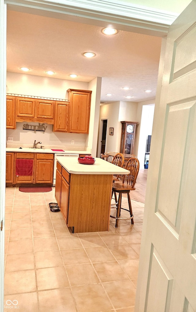 6956 Park Square Dr Unit D, Avon, IN 46123 - kitchen with light countertops, a sink, light tile patterned flooring, brown cabinets, and recessed lighting