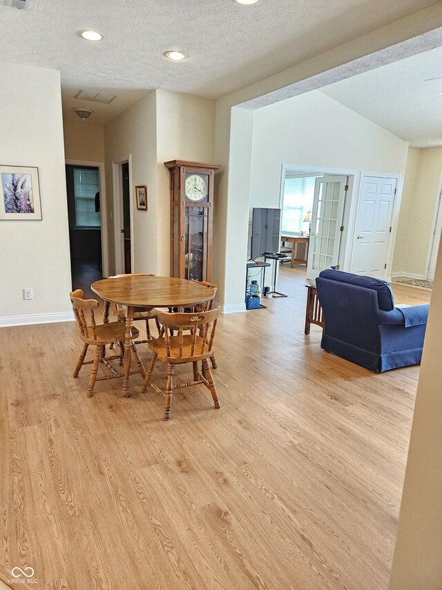 6956 Park Square Dr Unit D, Avon, IN 46123 - dining space featuring light wood-style flooring, a textured ceiling, baseboards, vaulted ceiling, and recessed lighting