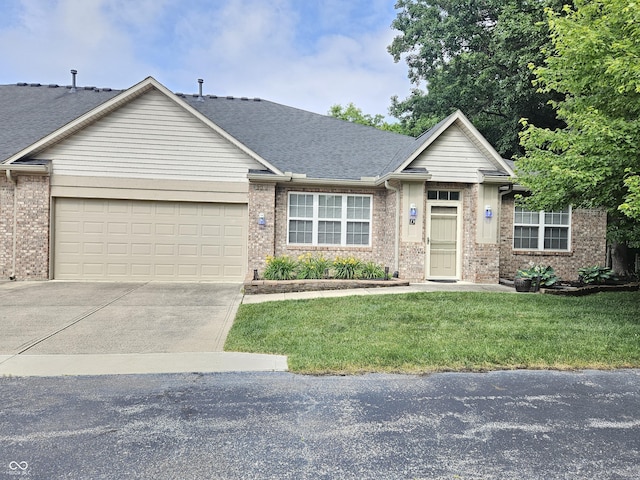 6956 Park Square Dr Unit D, Avon, IN 46123 - view of front of house with an attached garage, driveway, brick siding, and a front lawn
