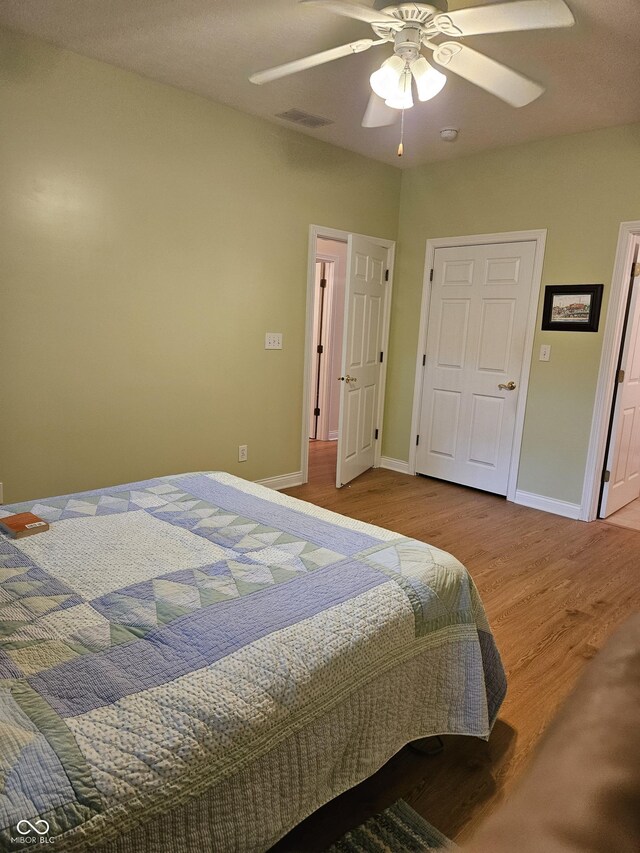 6956 Park Square Dr Unit D, Avon, IN 46123 - bedroom with wood finished floors, baseboards, and a ceiling fan