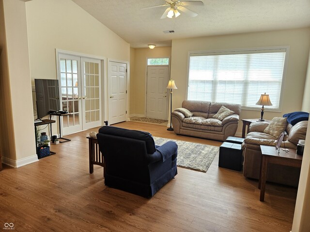 6956 Park Square Dr Unit D, Avon, IN 46123 - living room featuring a ceiling fan, wood finished floors, vaulted ceiling, baseboards, and french doors