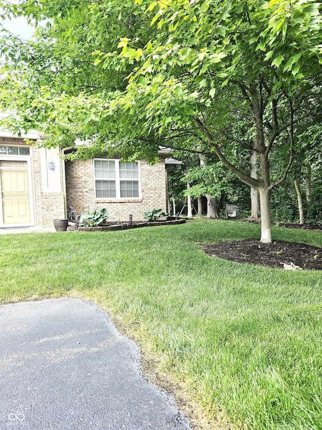 6956 Park Square Dr Unit D, Avon, IN 46123 - view of property hidden behind natural elements with a front lawn and brick siding