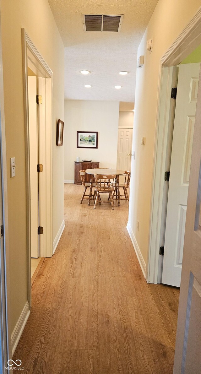 6956 Park Square Dr Unit D, Avon, IN 46123 - hallway featuring light wood-style floors and baseboards