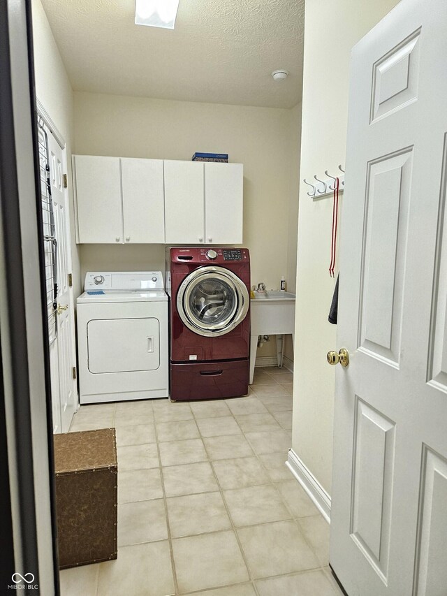 6956 Park Square Dr Unit D, Avon, IN 46123 - laundry area with cabinet space, washer and clothes dryer, baseboards, light tile patterned floors, and a textured ceiling