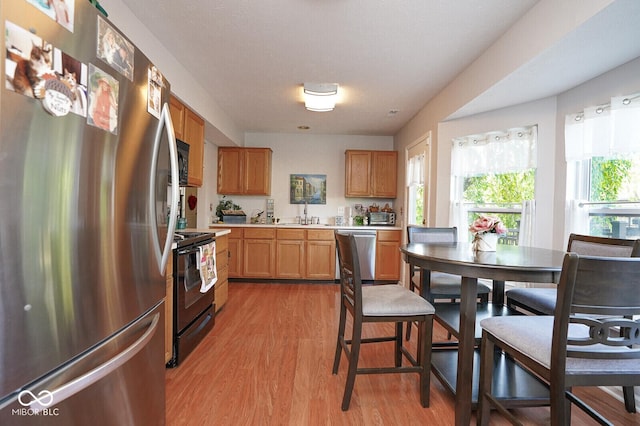4342 Sequoia Ct, Greenwood, IN 46143 - kitchen featuring stainless steel appliances, light wood-style flooring, light countertops, and a sink