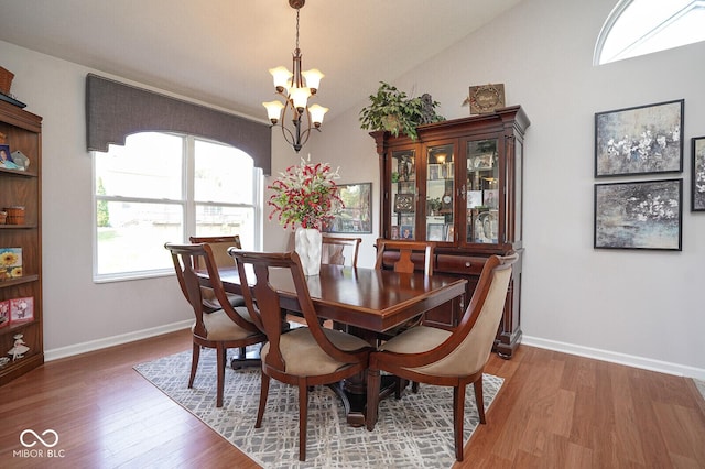 4342 Sequoia Ct, Greenwood, IN 46143 - dining area featuring a chandelier, wood finished floors, baseboards, and vaulted ceiling