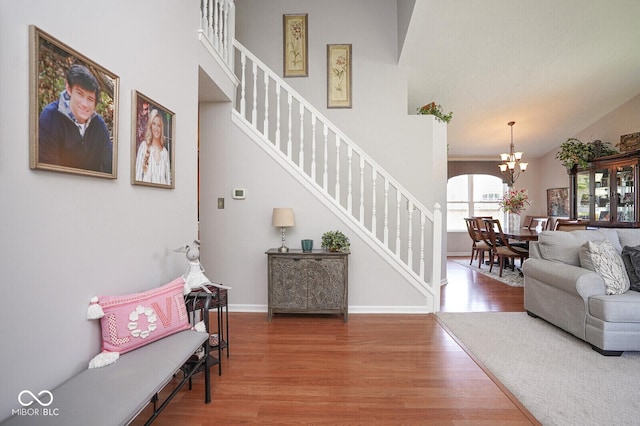 4342 Sequoia Ct, Greenwood, IN 46143 - entrance foyer featuring wood finished floors, stairs, a chandelier, a high ceiling, and baseboards