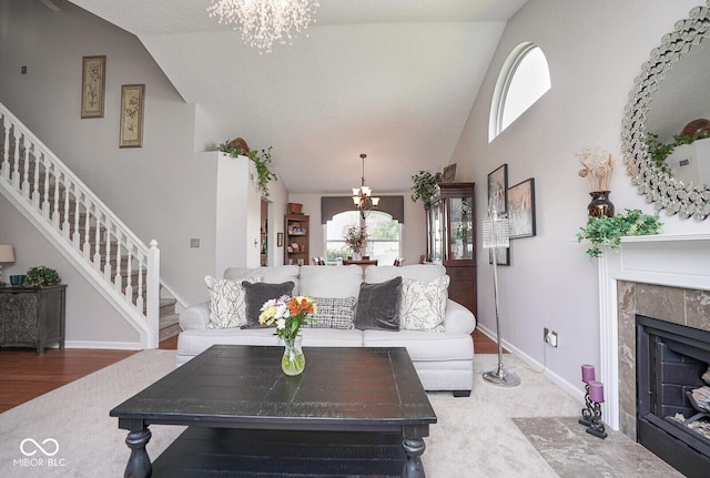 4342 Sequoia Ct, Greenwood, IN 46143 - living room with a chandelier, high vaulted ceiling, stairs, and a tiled fireplace