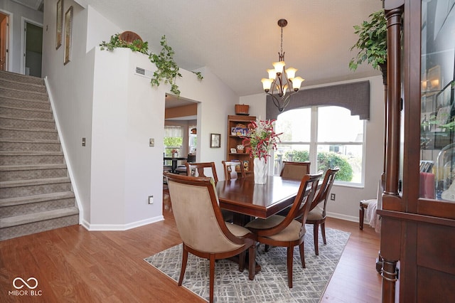 4342 Sequoia Ct, Greenwood, IN 46143 - dining room with a chandelier, healthy amount of natural light, stairs, and vaulted ceiling