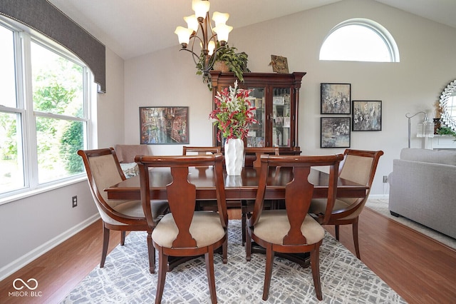 4342 Sequoia Ct, Greenwood, IN 46143 - dining area with vaulted ceiling, wood finished floors, a chandelier, baseboards, and healthy amount of natural light