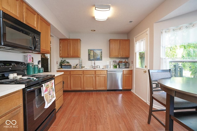 4342 Sequoia Ct, Greenwood, IN 46143 - kitchen with black appliances, a sink, light countertops, and light wood finished floors