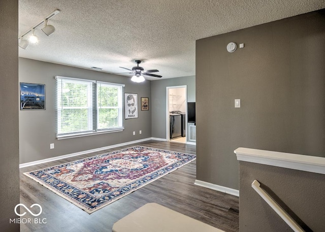 7657 Wheatgrass Ln, Noblesville, IN 46062 - spare room with wood finished floors, a textured ceiling, ceiling fan, track lighting, and baseboards