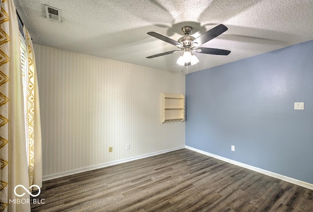 7657 Wheatgrass Ln, Noblesville, IN 46062 - spare room with dark wood finished floors, baseboards, ceiling fan, and a textured ceiling