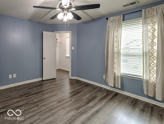 7657 Wheatgrass Ln, Noblesville, IN 46062 - empty room with ceiling fan, healthy amount of natural light, wood finished floors, and a textured ceiling
