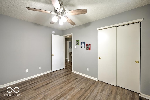 7657 Wheatgrass Ln, Noblesville, IN 46062 - unfurnished bedroom featuring wood finished floors, a closet, baseboards, a ceiling fan, and a textured ceiling