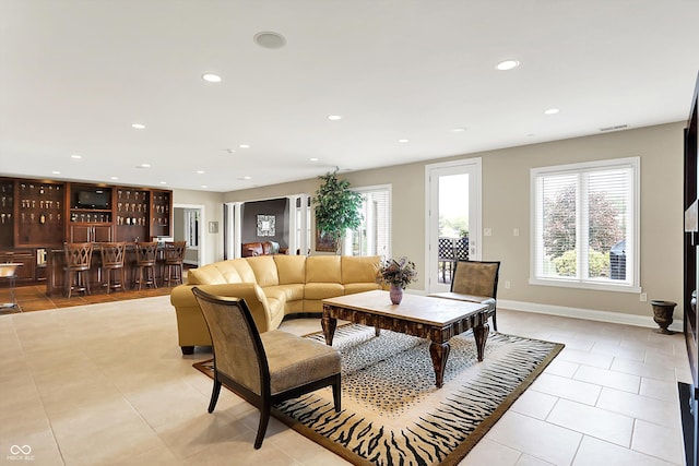 7635 Monte Carlo Way, Indianapolis, IN 46278 - living room featuring light tile patterned floors, recessed lighting, and bar