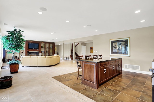 7635 Monte Carlo Way, Indianapolis, IN 46278 - kitchen featuring a kitchen bar, tile patterned floors, recessed lighting, a center island, and dark countertops