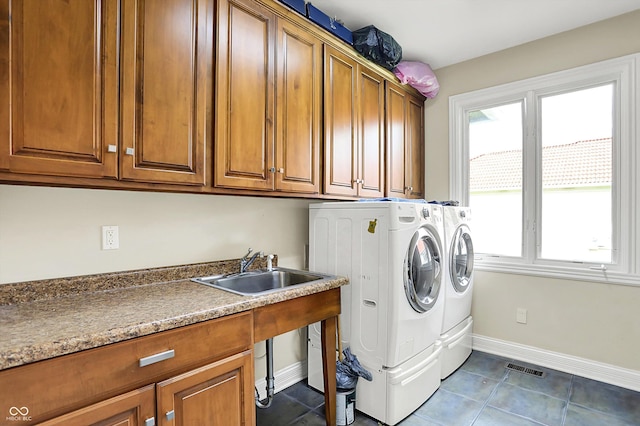 7635 Monte Carlo Way, Indianapolis, IN 46278 - washroom with independent washer and dryer, cabinet space, and dark tile patterned floors