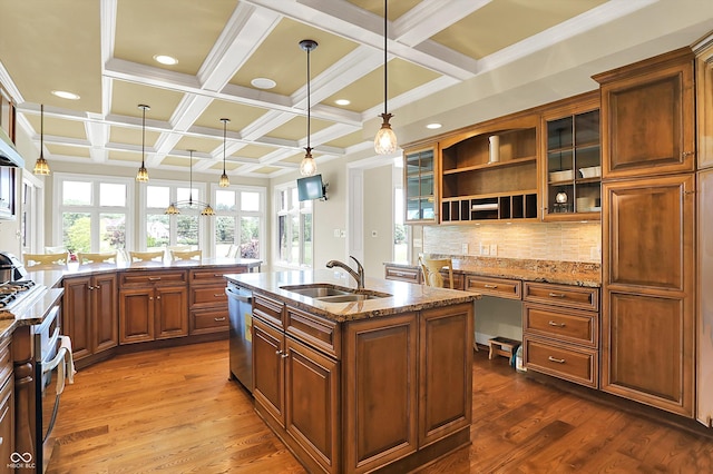 7635 Monte Carlo Way, Indianapolis, IN 46278 - kitchen featuring a kitchen island with sink, light stone counters, coffered ceiling, dark wood-type flooring, and brown cabinetry