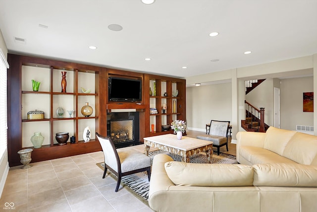 7635 Monte Carlo Way, Indianapolis, IN 46278 - living area featuring a glass covered fireplace, recessed lighting, stairs, and light tile patterned flooring