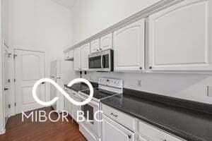 19146 Carol Cove Cir, Noblesville, IN 46062 - kitchen featuring electric stove, stainless steel microwave, dark countertops, and dark wood-type flooring