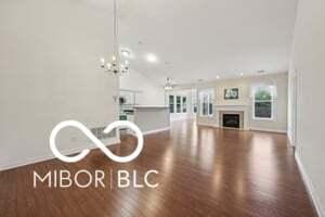 19146 Carol Cove Cir, Noblesville, IN 46062 - living room featuring baseboards, wood finished floors, and a fireplace