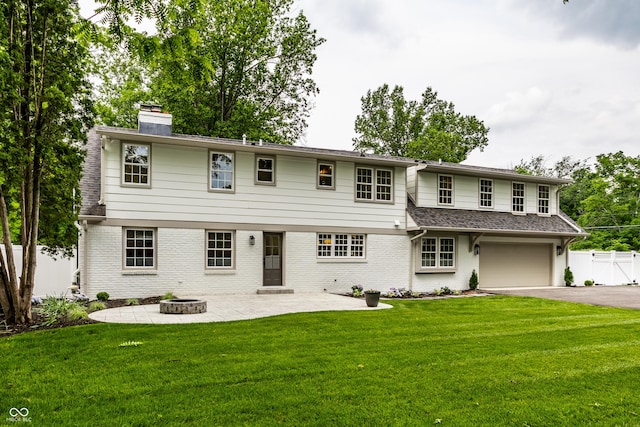 7105 Sylvan Ridge Rd, Indianapolis, IN 46240 - view of front of house featuring a chimney, an attached garage, asphalt driveway, brick siding, and a patio area