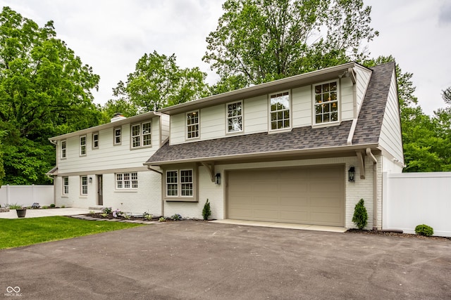 7105 Sylvan Ridge Rd, Indianapolis, IN 46240 - view of front facade featuring brick siding, a garage, roof with shingles, driveway, and a chimney