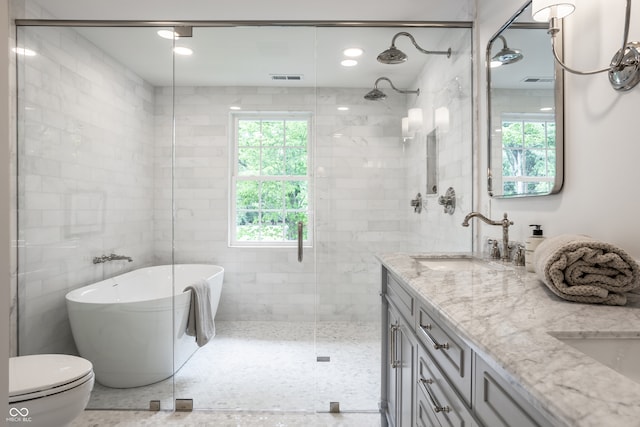 7105 Sylvan Ridge Rd, Indianapolis, IN 46240 - bathroom featuring a freestanding bath, a shower stall, double vanity, and toilet