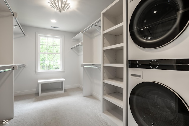 7105 Sylvan Ridge Rd, Indianapolis, IN 46240 - laundry room featuring stacked washing machine and dryer, carpet flooring, and baseboards