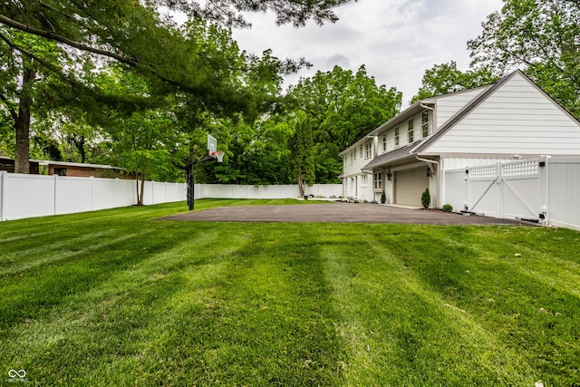7105 Sylvan Ridge Rd, Indianapolis, IN 46240 - view of yard with asphalt driveway, a gate, and a garage