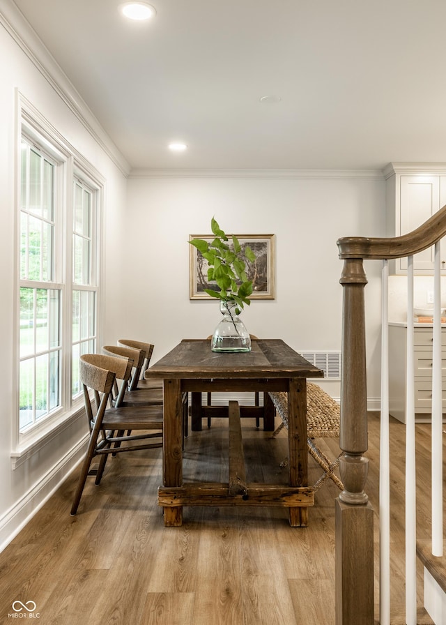 7105 Sylvan Ridge Rd, Indianapolis, IN 46240 - dining room with crown molding, baseboards, light wood-style flooring, recessed lighting, and stairway