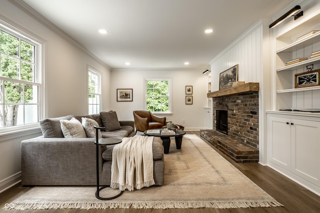 7105 Sylvan Ridge Rd, Indianapolis, IN 46240 - living area featuring dark wood-style flooring, ornamental molding, a brick fireplace, recessed lighting, and baseboards
