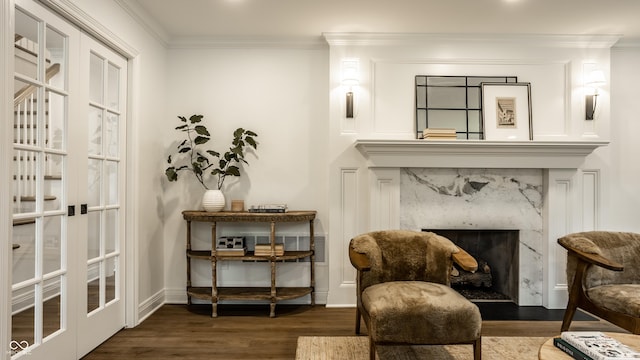 7105 Sylvan Ridge Rd, Indianapolis, IN 46240 - sitting room with wood finished floors, french doors, a fireplace, ornamental molding, and baseboards