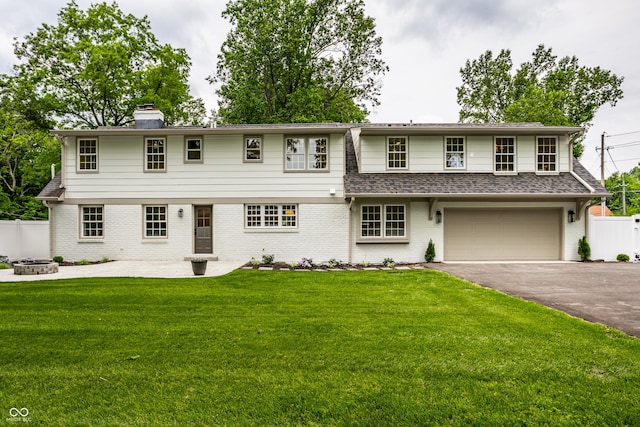 7105 Sylvan Ridge Rd, Indianapolis, IN 46240 - view of front facade with a fire pit, driveway, brick siding, and an attached garage