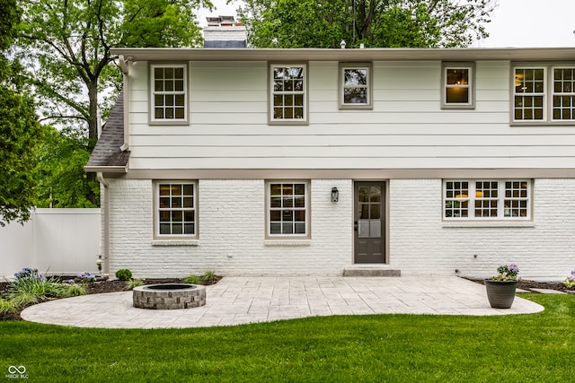 7105 Sylvan Ridge Rd, Indianapolis, IN 46240 - rear view of house with a patio, a chimney, a fire pit, and brick siding