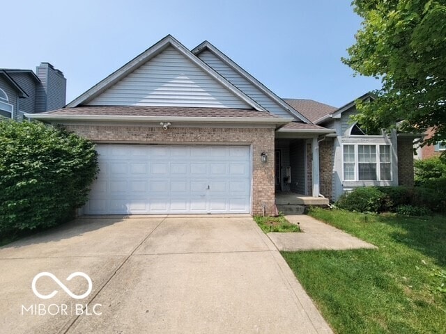 3714 Turfway Ct, Indianapolis, IN 46228 - ranch-style house featuring concrete driveway, a garage, brick siding, and a front lawn